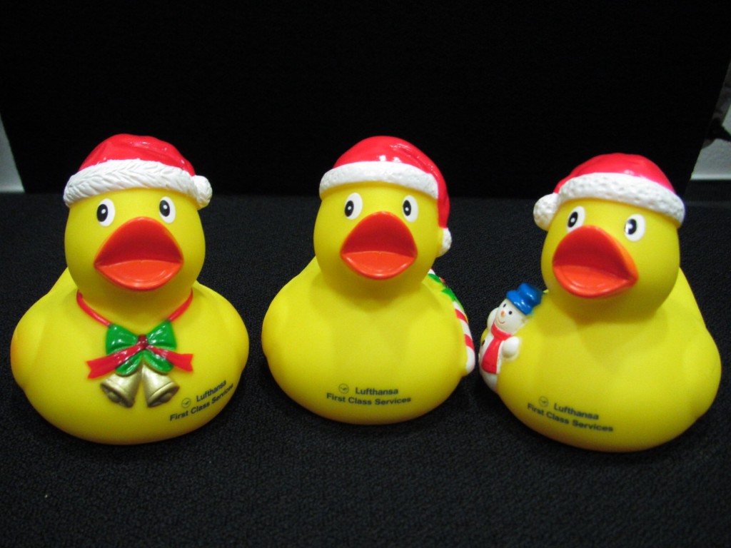 a group of yellow rubber ducks with santa hats