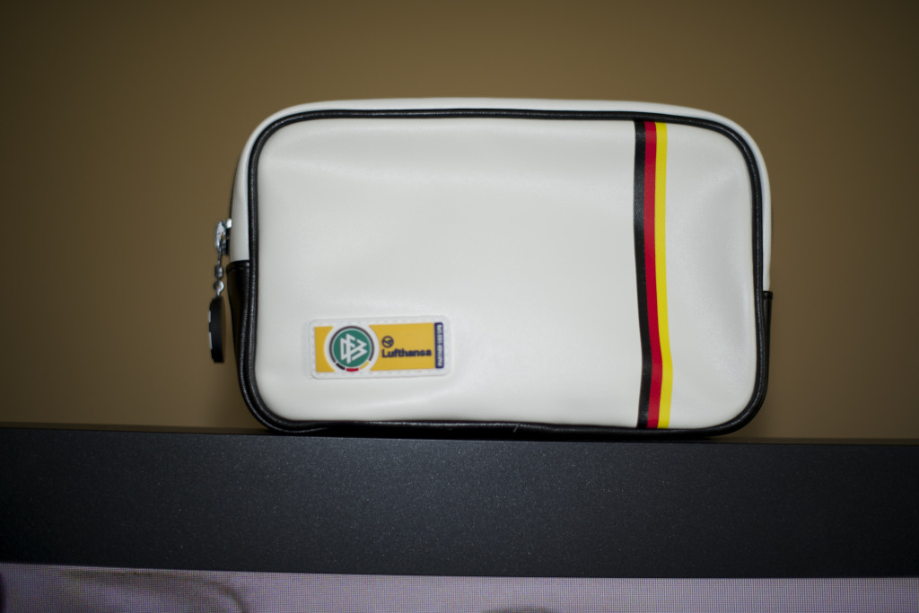 a white bag with a red stripe and a yellow and black stripe