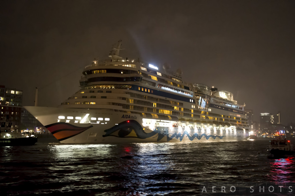 a large cruise ship in the water at night