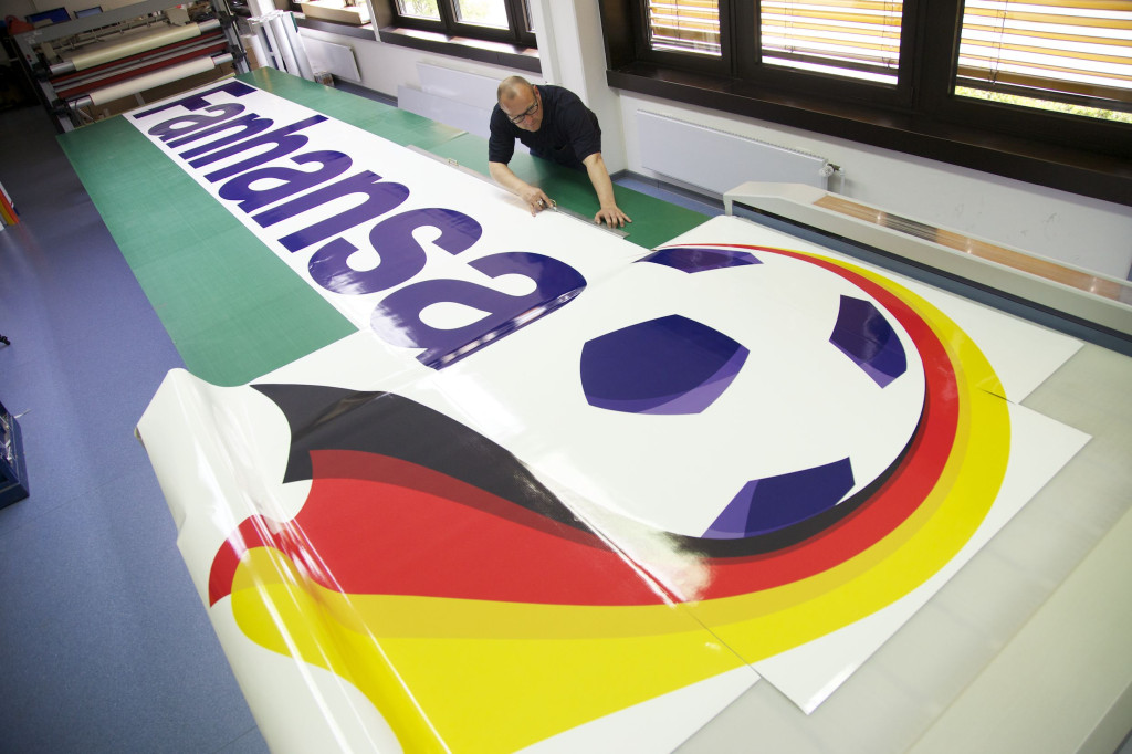 a man working on a large sign