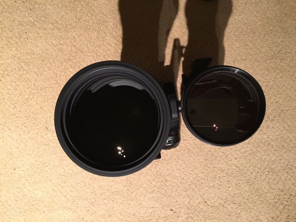 a black camera lens with a round lens