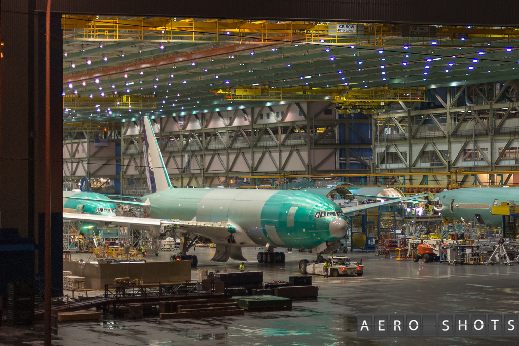 an airplane in a hangar with Boeing Renton Factory in the background