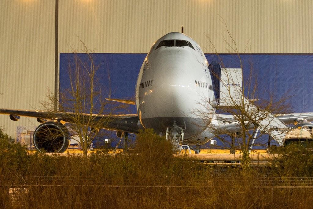 a large airplane parked in front of a building