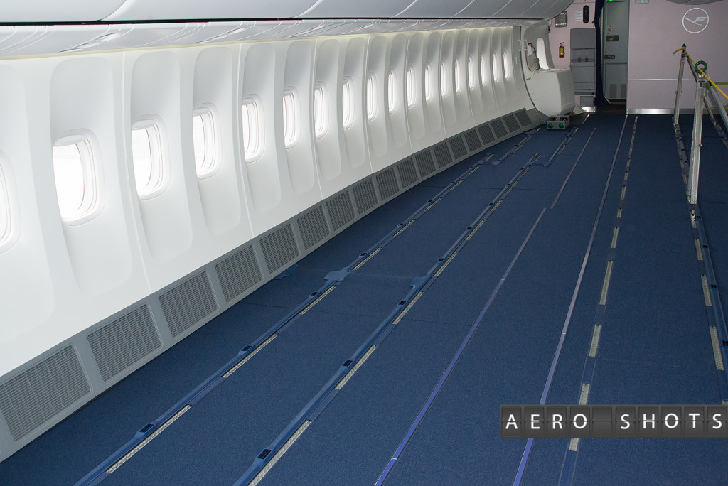 an airplane with blue carpet and windows