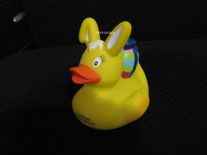 a yellow rubber duck with bunny ears