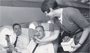 a woman standing next to a man in a plane