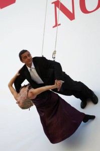 a man in a suit holding a woman in a swing