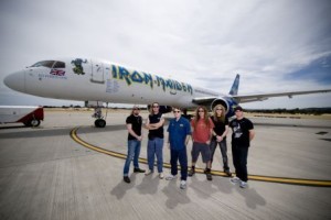 a group of people standing in front of an airplane