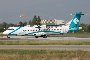 a white and blue airplane on a runway