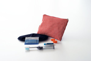 a red and white checkered pillow and toothbrushes