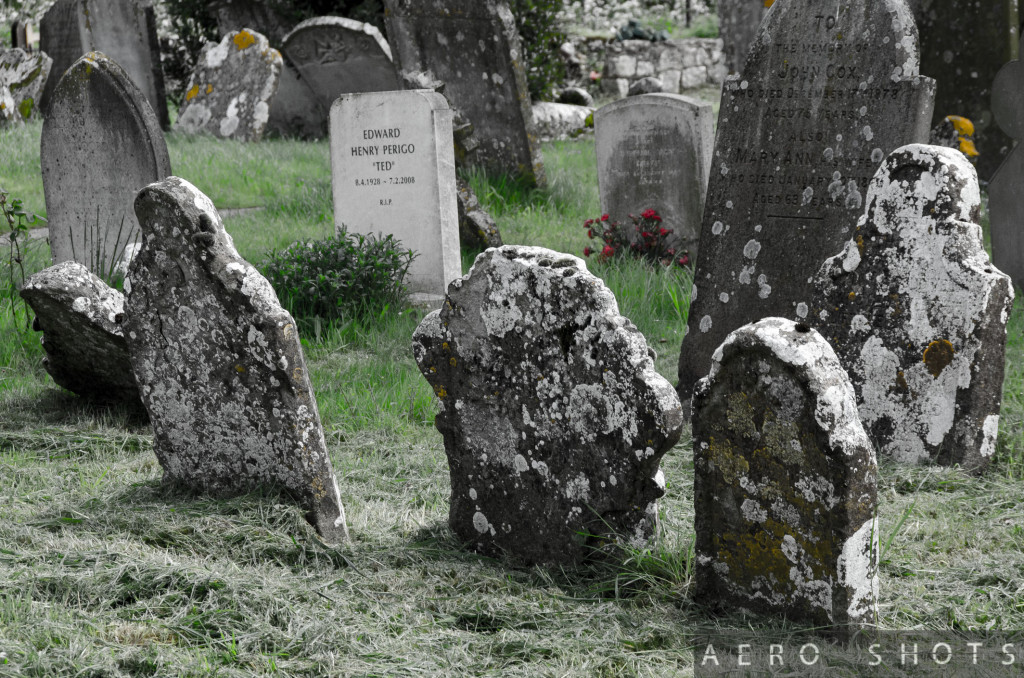 A moden tombstone stands out among its ancient peers.