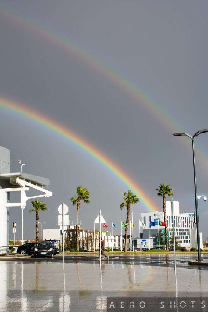 This sight was waiting for me as I exited the terminal.   If you look closely, you can see that the rainbow spilled its colors into the flags......