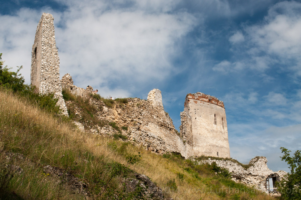 a stone castle ruins on a hill