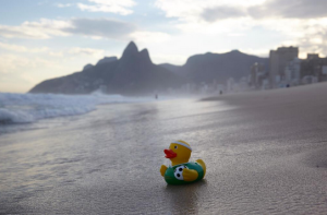 a yellow rubber duck on a beach