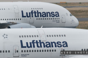 two white airplanes with blue writing on them