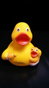 a yellow rubber duck with a baby duckling