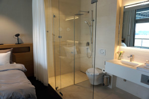 a bathroom with a glass shower and a toilet