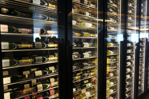 a glass case with bottles of wine
