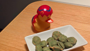 a toy duck next to a plate of food