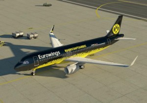 a black and yellow airplane on a runway