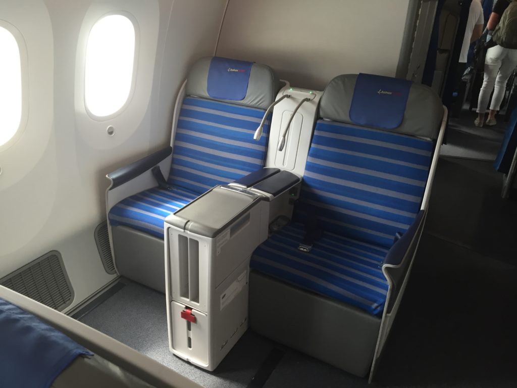 a blue and grey seats in an airplane