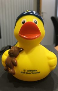a yellow rubber duck with a bear on its back