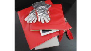 a red bag with gloves and a tablet on top