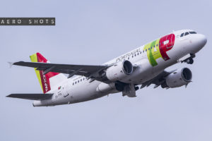a white airplane with green and red text