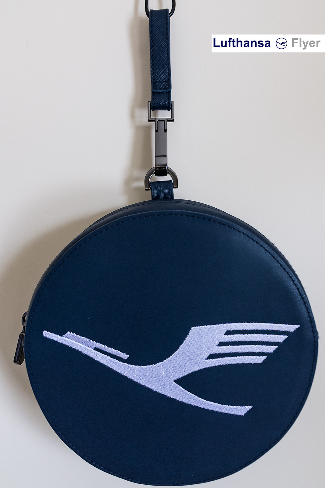 a blue round bag with a white logo on it
